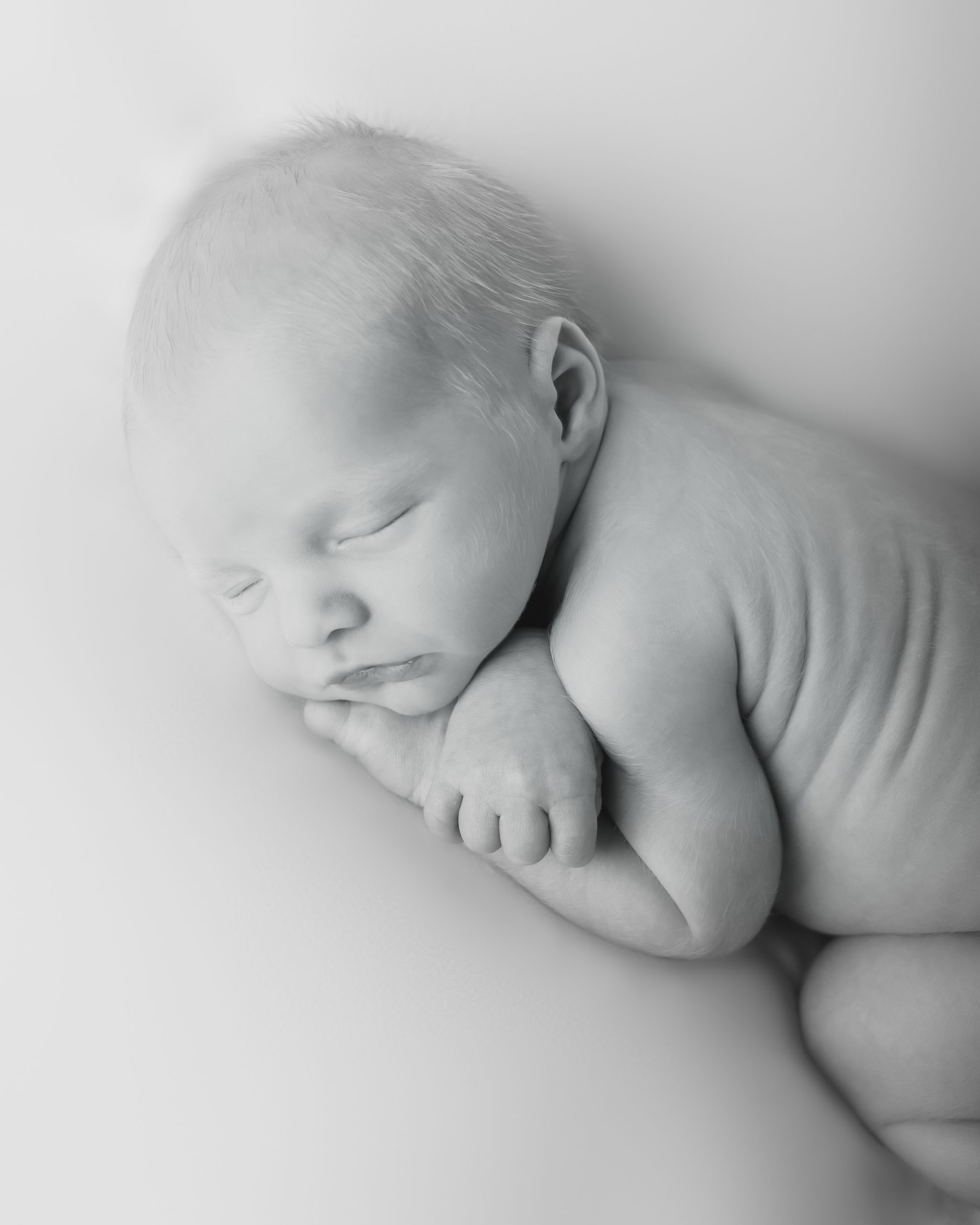 Milwaukee baby photography image with baby laying on a beanbag